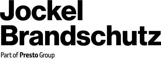 Das Logo für Jockel Brandschutz Group. Es hat rote Schrift mit einem roten Ring darum herum.